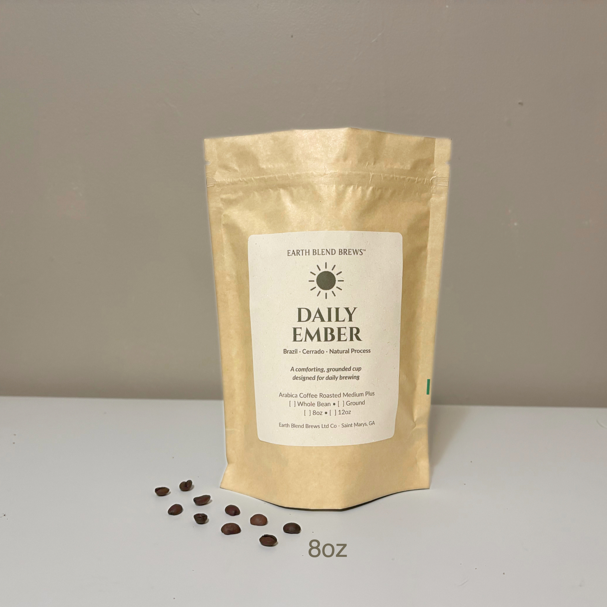8oz Coffee package labeled 'Daily Ember' by Earth Blend Brews on a plain background