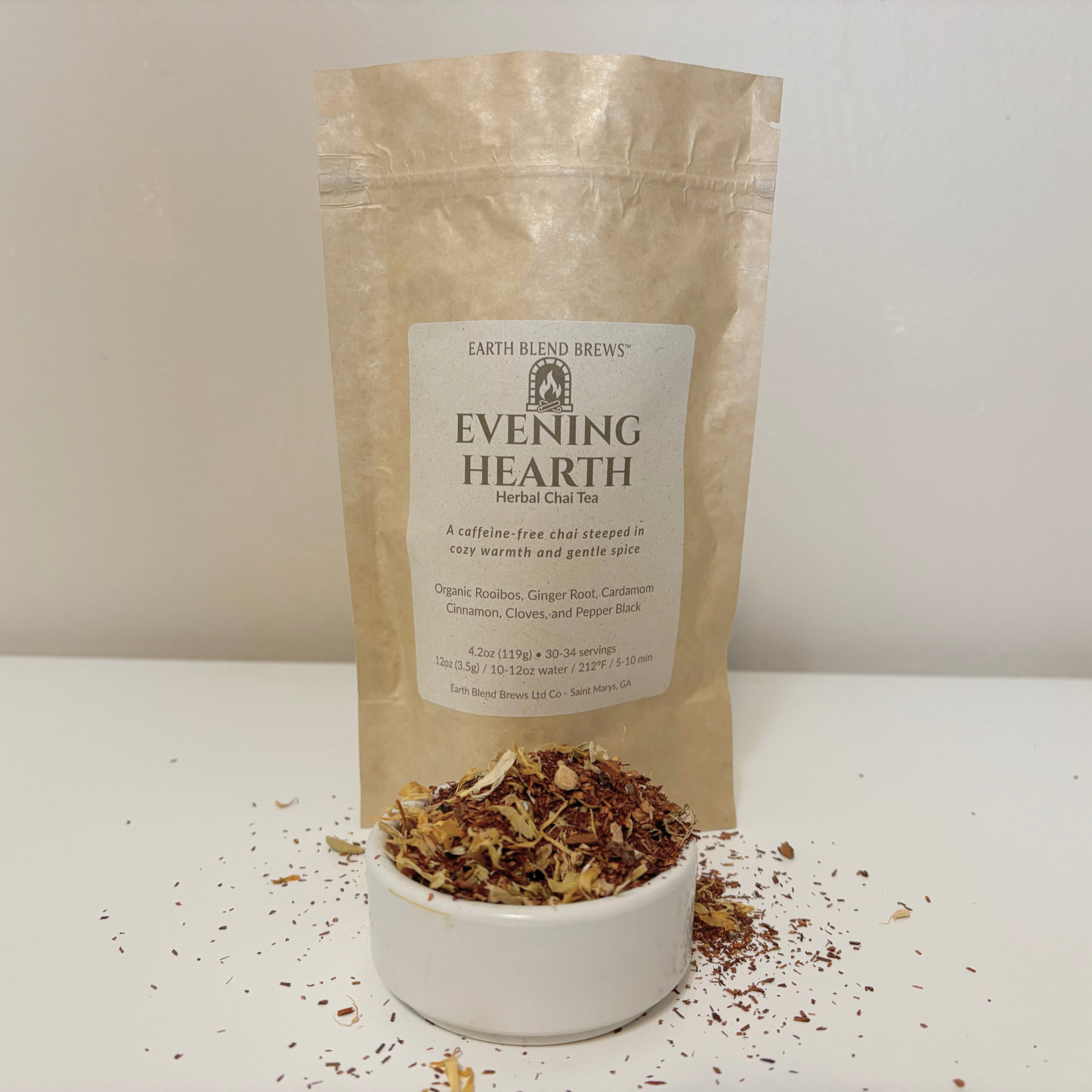 Bag of Earth Blend Brews Evening Hearth Herbal Chai Tea with tea leaves in a bowl on a white background