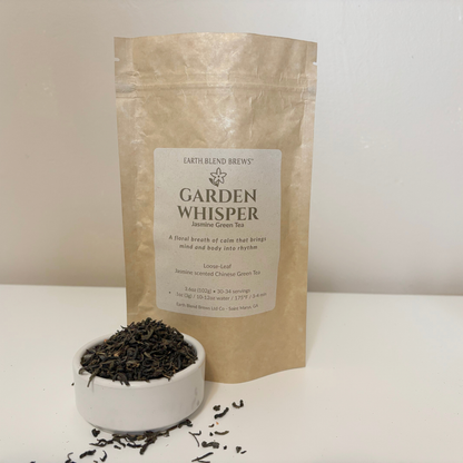 Tea packaging labeled 'Garden Whisper' with loose tea leaves in a bowl on a white background
