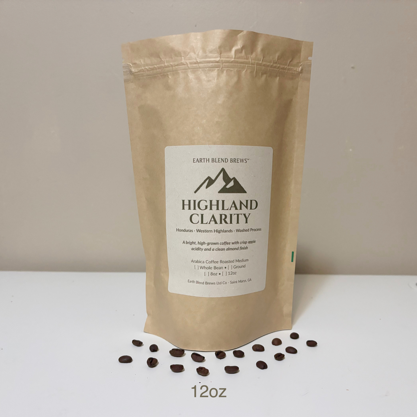 12oz Kraft paper coffee bag labeled 'Highland Clarity' with coffee beans on a white surface.