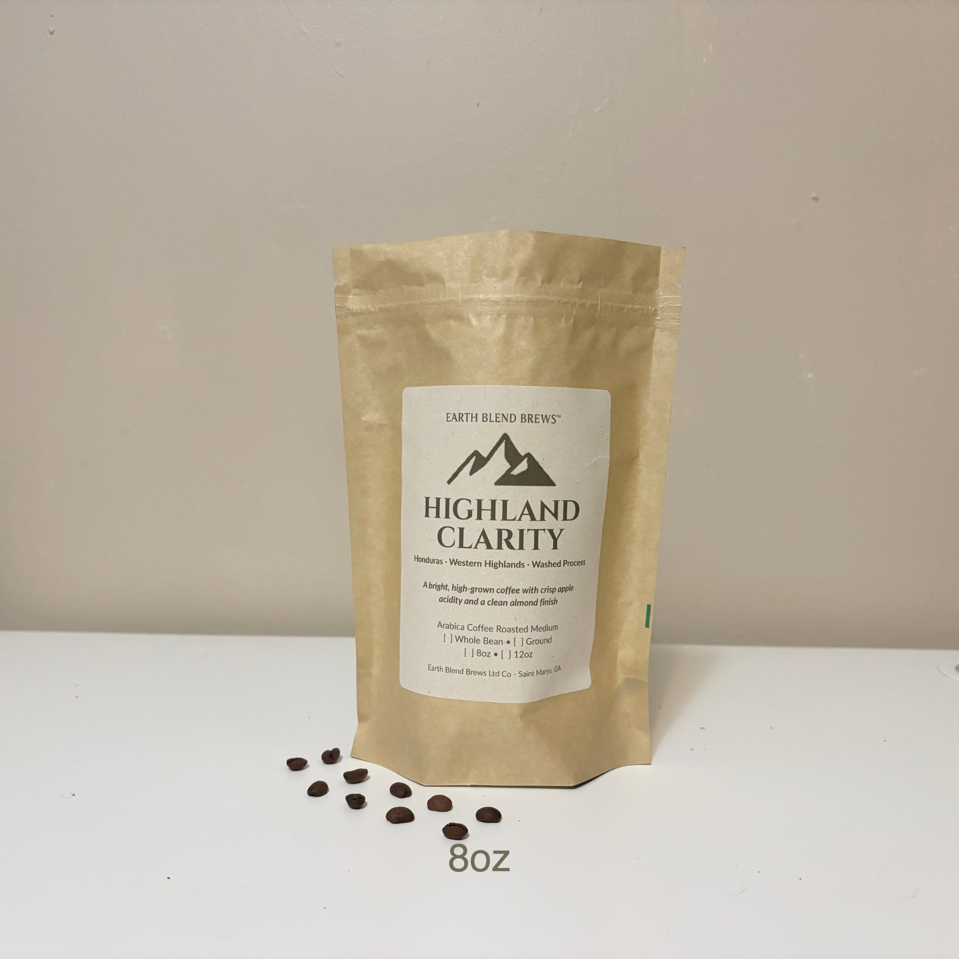 8oz Kraft paper coffee bag labeled 'Highland Clarity' with coffee beans on a white surface and beige background