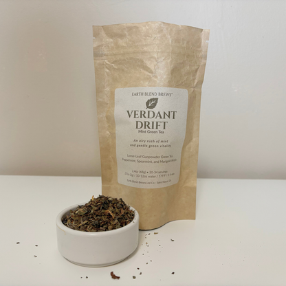 Tea packaging with a label 'VERDANT  DRIFT' and a bowl of tea leaves on a white background